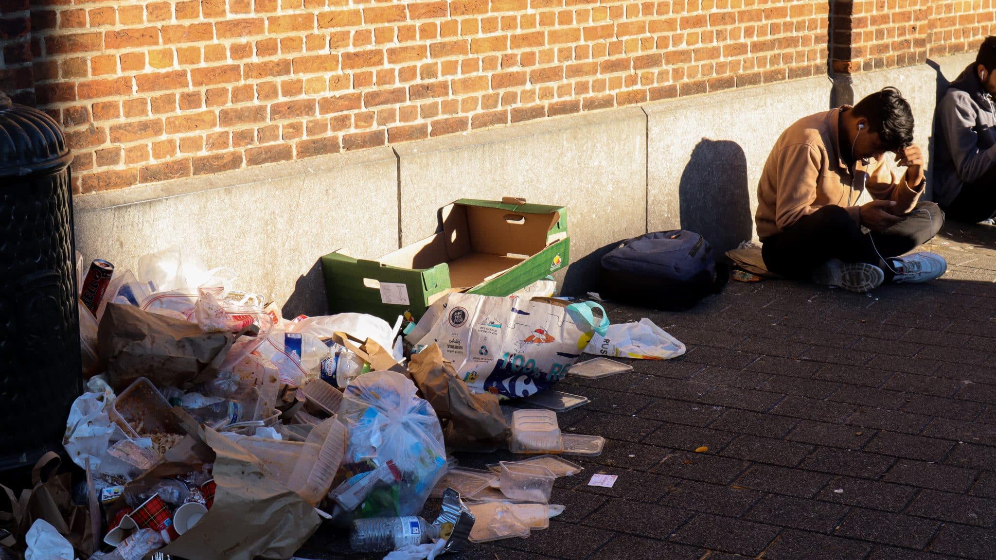 A refugee waiting for the procedure at Fedasil in Brussels, next to a pile of garbage. 